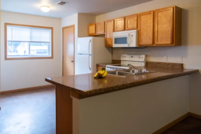 Cabinets microwave stove refrigerator bananas kitchen at Conifer Creek Townhomes in Allendale Student Accommodation
