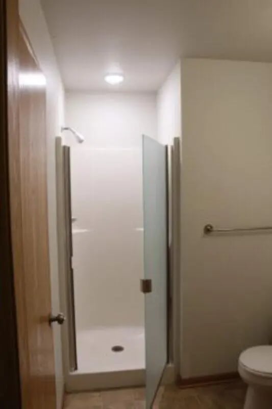 Shower stall with glass door and toilet bathroom at Conifer Creek Townhomes in Allendale Student Accommodation
