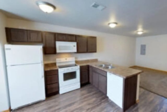 White refrigerator stove microwave dark cabinets kitchen at Conifer Creek Townhomes in Allendale Student Accommodation