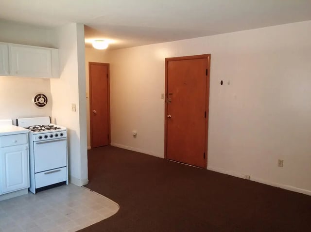 White stove two doors brown carpet living kitchen at Campus East in Milwaukee Student Accommodation