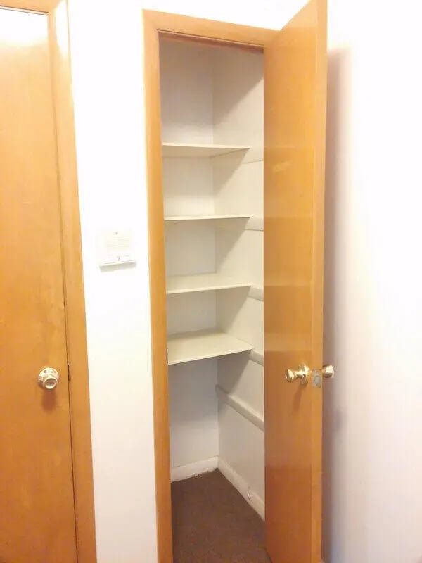 Empty storage closet with white shelves storage closet at Campus East in Milwaukee Student Accommodation