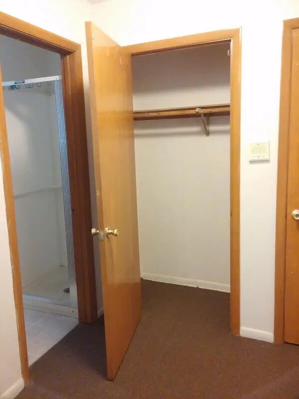 Shower stall and open closet interior image at Campus East in Milwaukee Student Accommodation