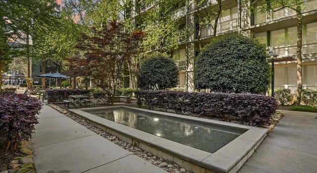 Rectangular reflecting pool with surrounding landscaping exterior at 1016 Lofts in Atlanta Student Accommodation