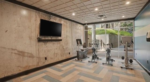 Exercise bikes television and large window fitness area at 1016 Lofts in Atlanta Student Accommodation