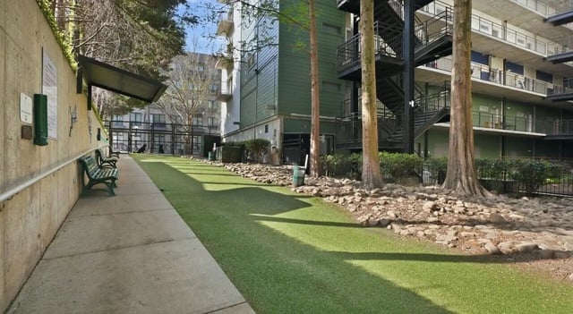 Dog park with benches and faux grass exterior at 1016 Lofts in Atlanta Student Accommodation