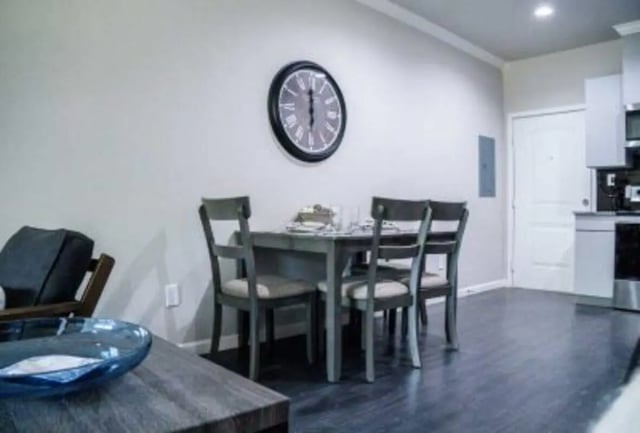 Dining table four chairs wall clock living area at 625 at Prairie View Apartments in Prairie View Student Accommodation