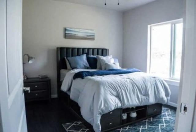 Bed nightstand desk lamp wall art bedroom at 625 at Prairie View Apartments in Prairie View Student Accommodation