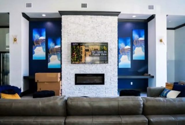 Sofa fireplace TV art stack living room at 625 at Prairie View Apartments in Prairie View Student Accommodation