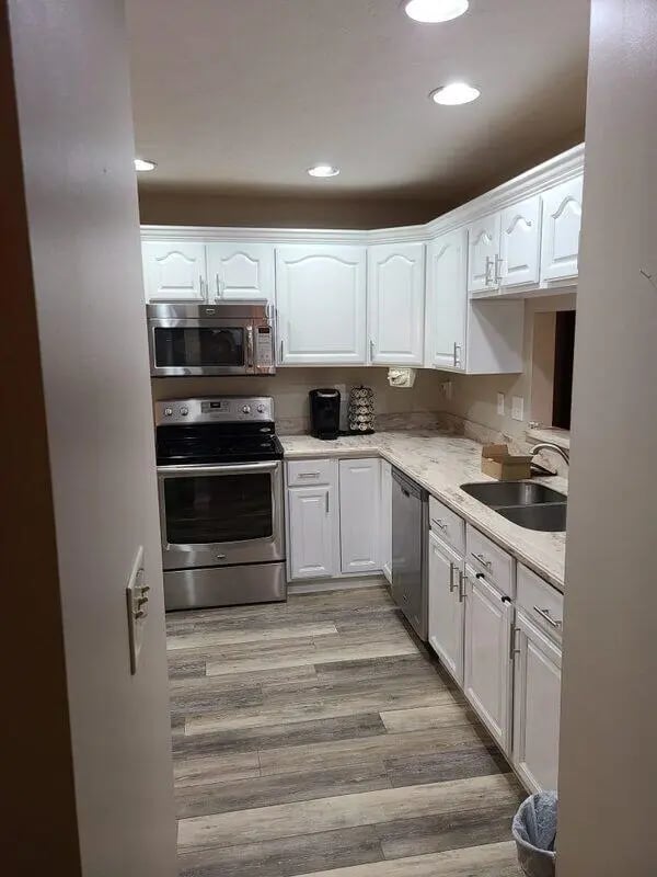 Modern white kitchen with stainless steel appliances kitchen at 142 Ashley St - Ashley House Apartments in Dayton Student Accommodation