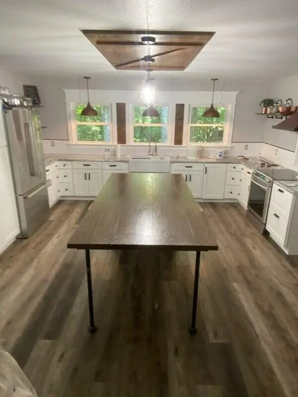 Large island stainless steel fridge white cabinets kitchen at 142 Ashley St - Ashley House Apartments in Dayton Student Accommodation