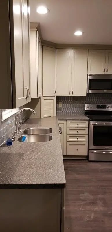 Kitchen cabinets sink faucet stove and drawers kitchen at 142 Ashley St - Ashley House Apartments in Dayton Student Accommodation