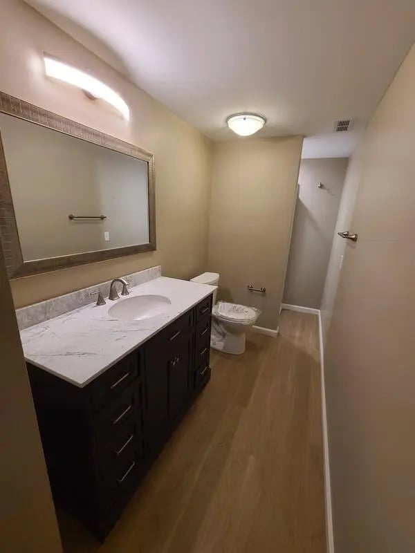 Vanity sink toilet and mirror bathroom at 142 Ashley St - Ashley House Apartments in Dayton Student Accommodation