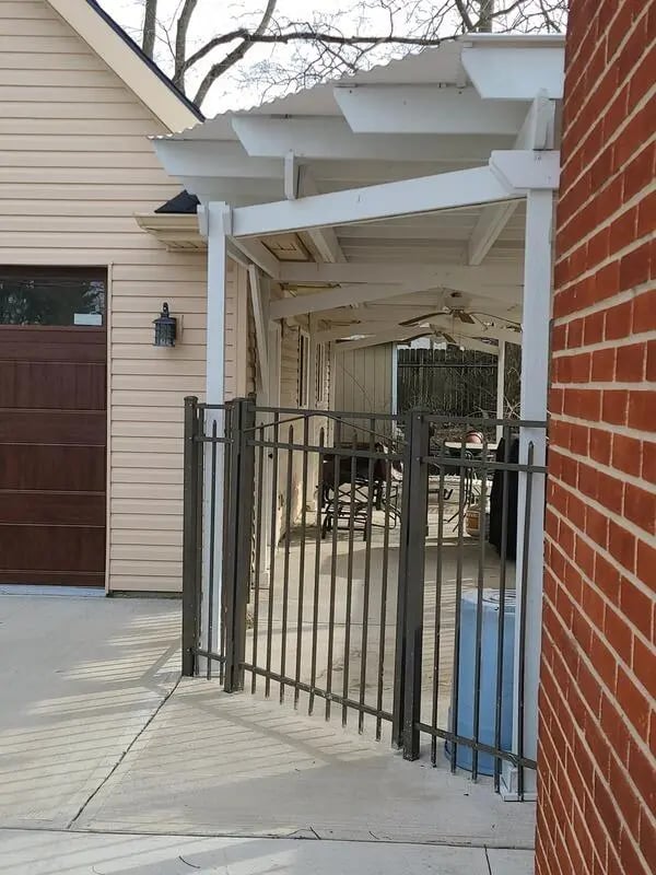 Exterior with garage door and covered patio exterior at 142 Ashley St - Ashley House Apartments in Dayton Student Accommodation