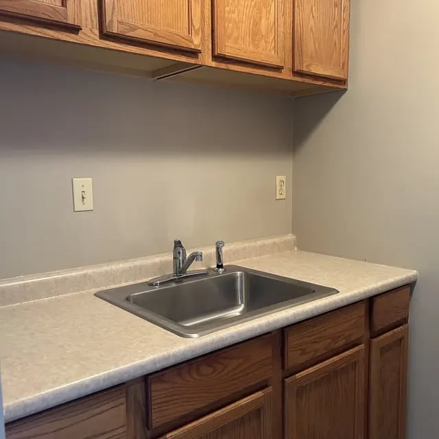 Stainless steel sink with faucet and cabinets kitchen at Adams House in Oxford Student Accommodation