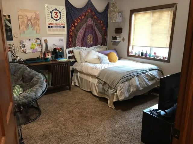 Bed desk chair posters tapestry bedroom at Clarks Landing Apartments in Vermillion Student Accommodation
