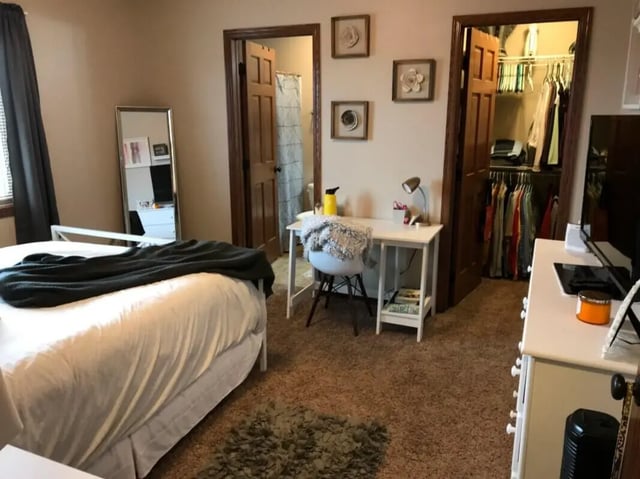 Bed desk closet mirror bedroom at Clarks Landing Apartments in Vermillion Student Accommodation