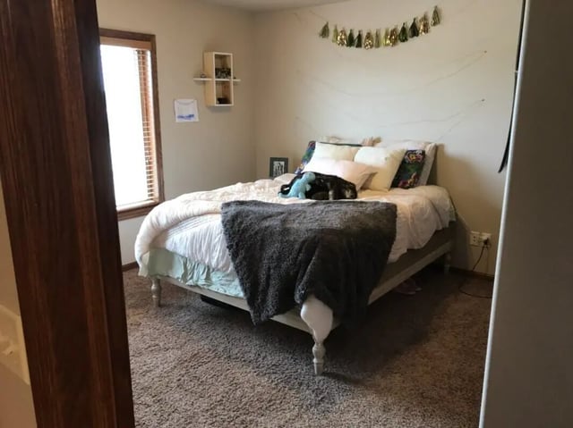Bed with pillows blanket and decor bedroom at Clarks Landing Apartments in Vermillion Student Accommodation