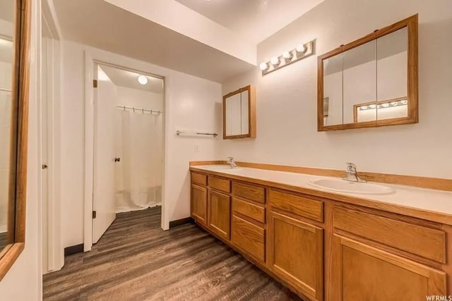 Double sinks wooden vanity and shower area bathroom at Alpine Canyon Student Housing - Snow College in Ephraim Student Accommodation