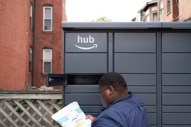 Man collecting package from Amazon Hub locker exterior at Campus Apartments Philadelphia in Philadelphia Student Accommodation