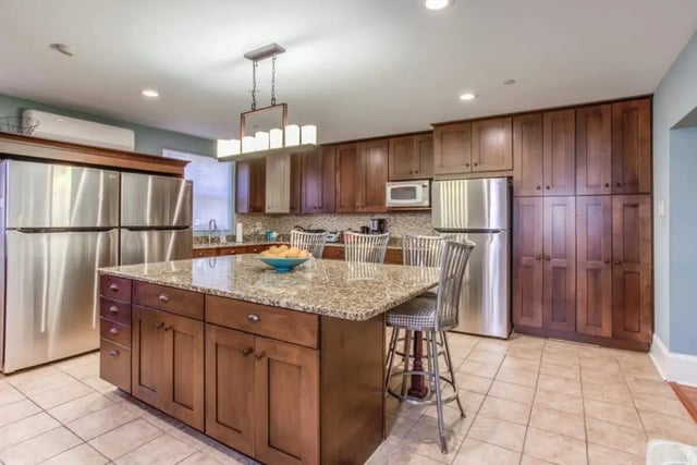 Island with bar stools and stainless refrigerators Kitchen at Campus Apartments Philadelphia in Philadelphia Student Accommodation