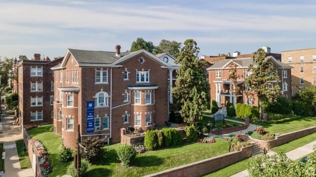 Brick apartment buildings with trees and lawn exterior at Campus Apartments Philadelphia in Philadelphia Student Accommodation