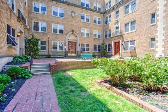 Brick pathway garden bench grass courtyard exterior at Campus Apartments Philadelphia in Philadelphia Student Accommodation