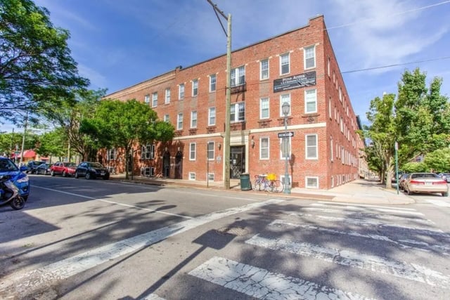 Brick building with bikes and cars exterior at Campus Apartments Philadelphia in Philadelphia Student Accommodation
