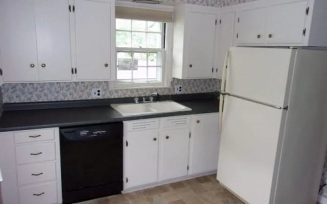 White cabinets dishwasher sink refrigerator kitchen at Better Ball State Rentals in Muncie Student Accommodation