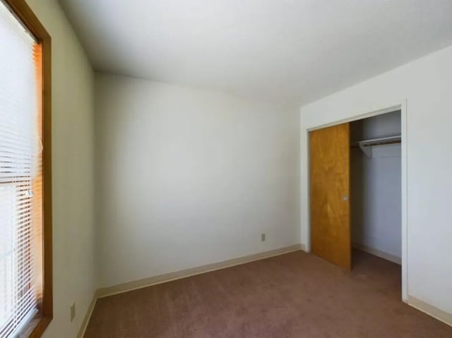 Carpeted floor open closet sliding door bedroom at Chesterfield Apartments Muncie in Muncie Student Accommodation