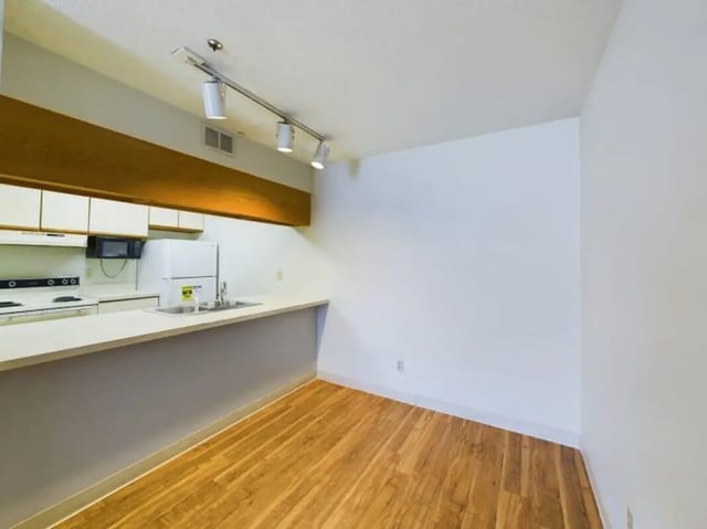 White cabinets stove refrigerator sink kitchen at Chesterfield Apartments Muncie in Muncie Student Accommodation