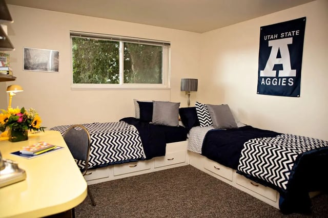 Two beds with chevron bedding and drawers Bedroom at Alpine Flats (NOW UNIVERSITY LANDING) in Logan Student Accommodation