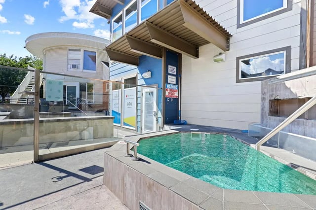Jacuzzi with lounge area exterior at Alpine Flats (NOW UNIVERSITY LANDING) in Logan Student Accommodation