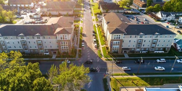 Apartment buildings with cars on street exterior at Beacon Commons in Springfield Student Accommodation