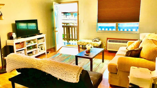 TV shelf couch table patterned bench living room at Big Green Properties, LLC in Huntington Student Accommodation
