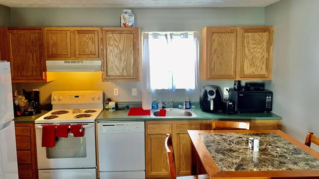 Kitchen with stove dishwasher microwave and table kitchen at Big Green Properties, LLC in Huntington Student Accommodation