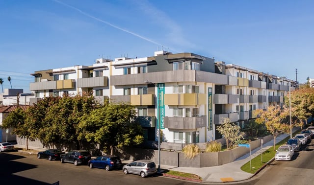 Modern apartment building with balconies and cars exterior at 1025 Berendo Villas in Los Angeles Student Accommodation