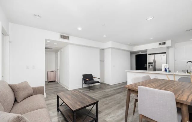 Sofa coffee table chairs and dining table living room at 1025 Berendo Villas in Los Angeles Student Accommodation