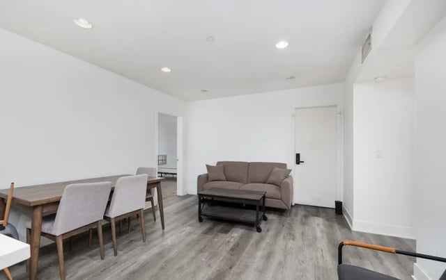 Dining table chairs sofa coffee table living room at 1025 Berendo Villas in Los Angeles Student Accommodation