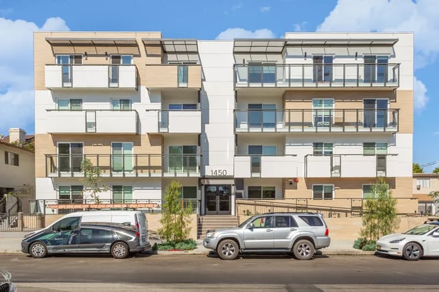 Modern apartment building exterior with balconies and cars exterior at 1025 Berendo Villas in Los Angeles Student Accommodation