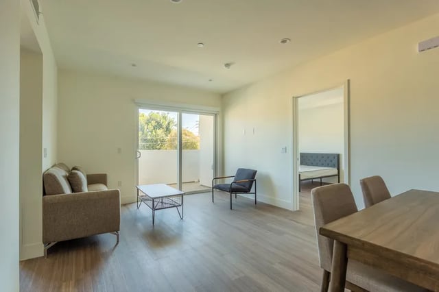 Sofa coffee table chair bed and dining table Living room at 1025 Berendo Villas in Los Angeles Student Accommodation