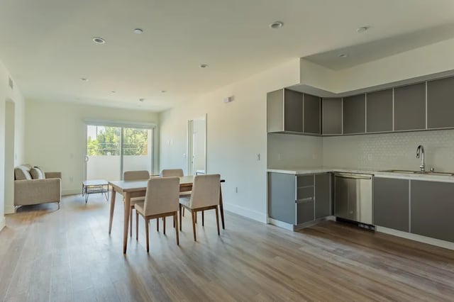 Sofa dining table chairs kitchen living area kitchen at 1025 Berendo Villas in Los Angeles Student Accommodation