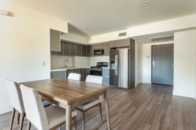 Dining table with chairs kitchen and refrigerator kitchen at 1025 Berendo Villas in Los Angeles Student Accommodation