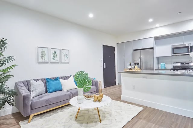 Sofa coffee table and kitchen living room at 1025 Berendo Villas in Los Angeles Student Accommodation