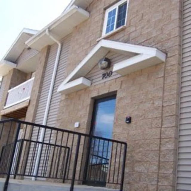 Building entrance with black railings exterior at Biondo Properties, LLC in La Crosse Student Accommodation