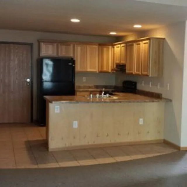 Kitchen with refrigerator cabinets and counter area Kitchen at Biondo Properties, LLC in La Crosse Student Accommodation