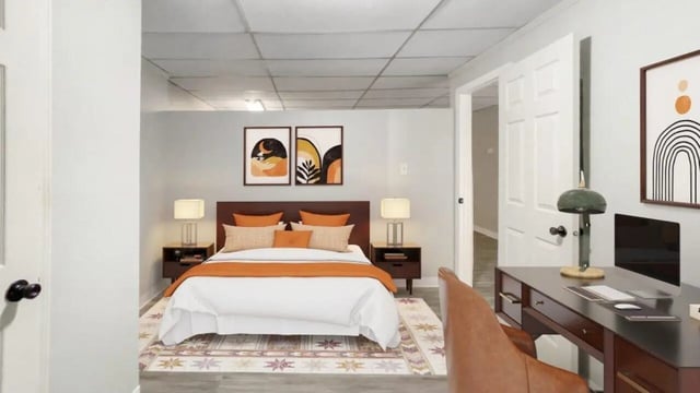 Bed with desk and paintings bedroom living room at Beacon Hill Apartments in Muncie Student Accommodation