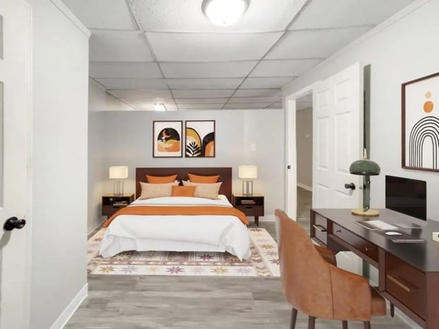 Bed with orange accents desk and chair bedroom at Beacon Hill Apartments in Muncie Student Accommodation
