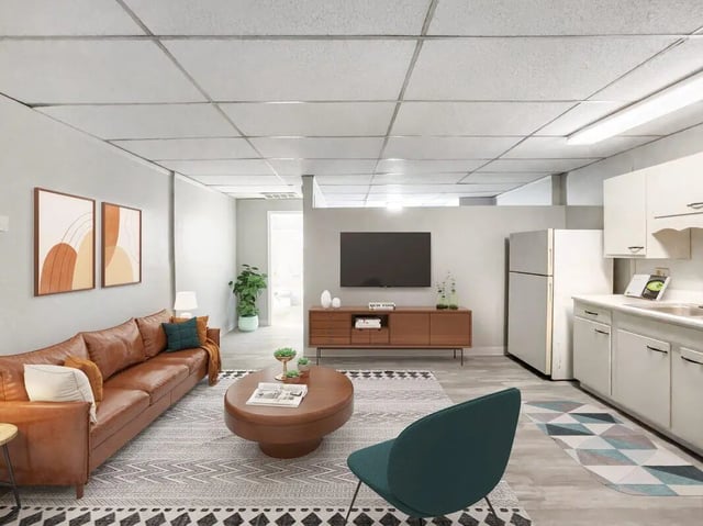 Brown leather sofa coffee table TV kitchen living room at Beacon Hill Apartments in Muncie Student Accommodation