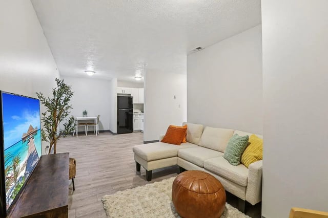 Sectional sofa kitchen and dining area living room at Beacon Hill Apartments in Muncie Student Accommodation