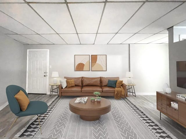 Brown leather couch circular coffee table living room at Beacon Hill Apartments in Muncie Student Accommodation